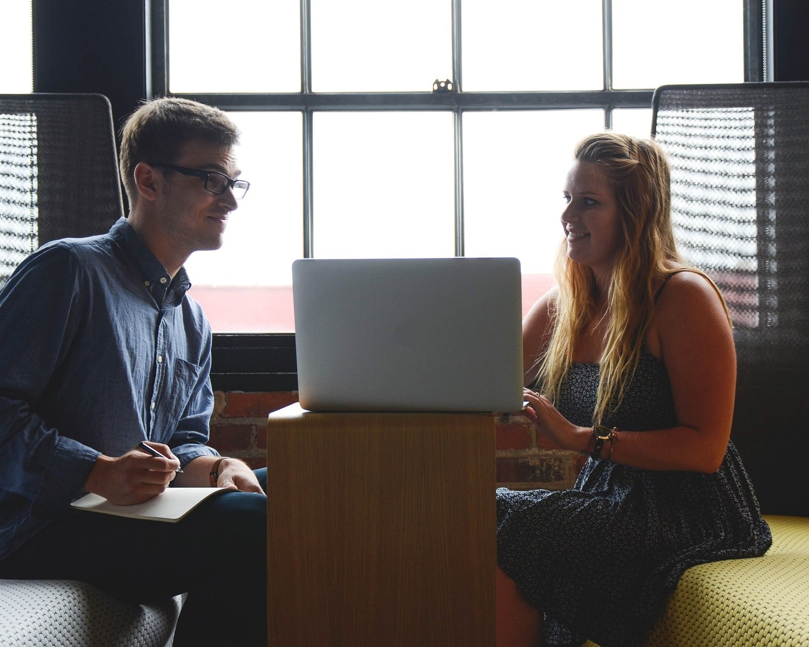 man and women looking at a laptop screen
